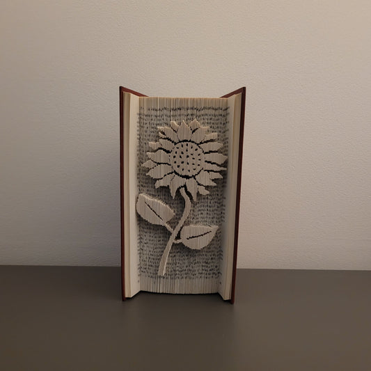 A picture of a book fold with a Sunflower on the front.