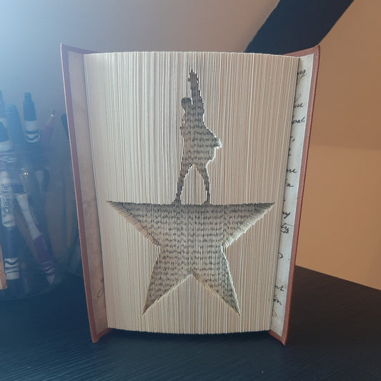 A book fold with a picture of Alexander Hamilton silhouette on the front.