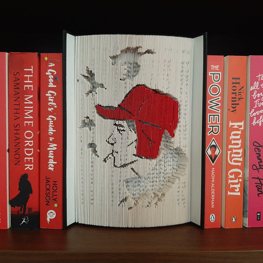 A book fold with a picture of Holden Caulfield, the main character from JD Salinger's novel, The Catcher in the Rye on the front