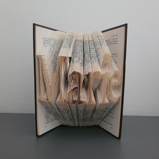 A folded book with the name "Marie" folded into it.
