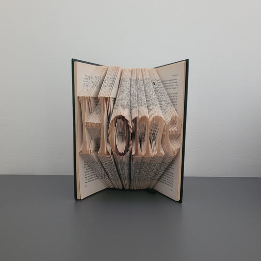 A book fold with the word "Home" on the front
