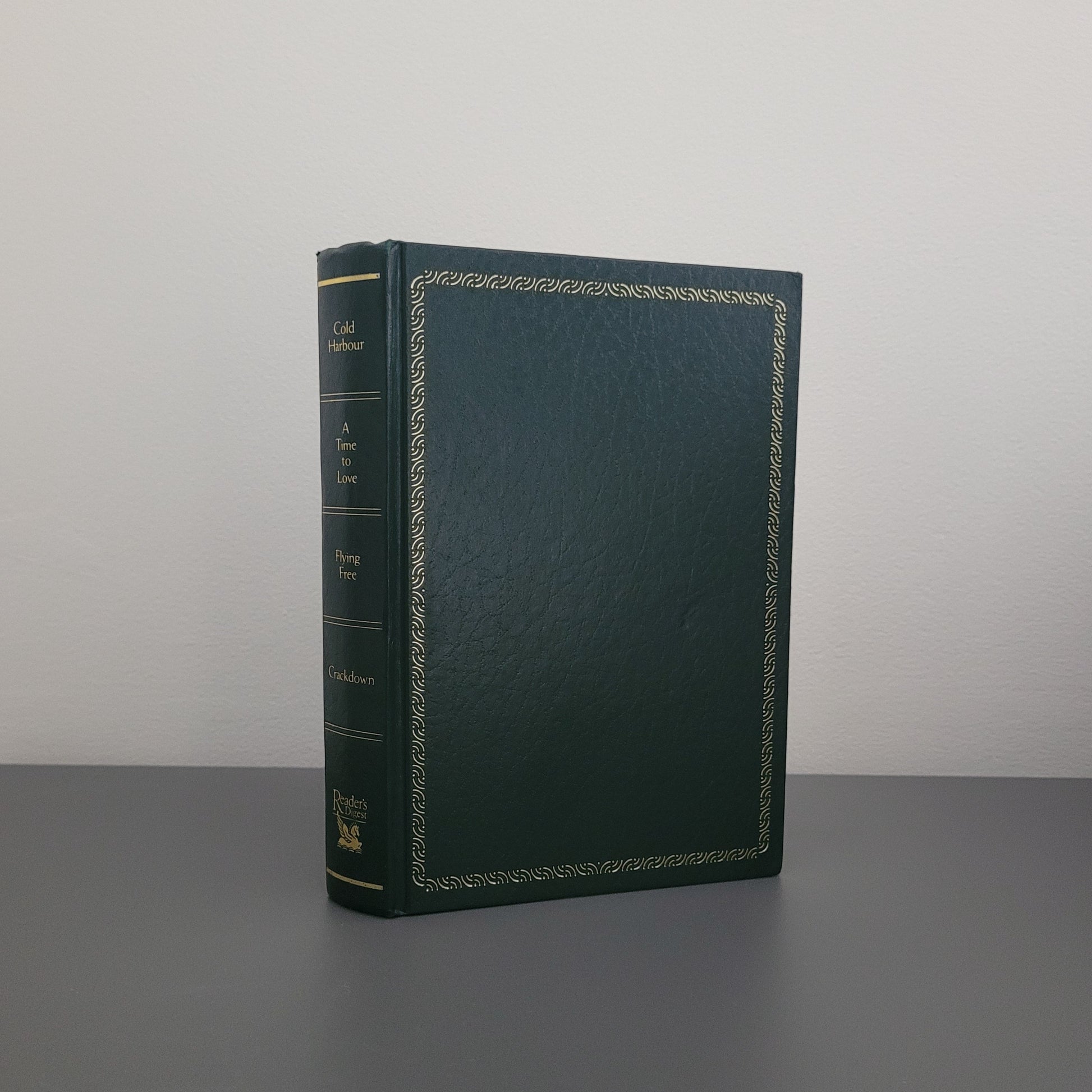 The front cover of the book fold - a dark green hardback book with a golden border