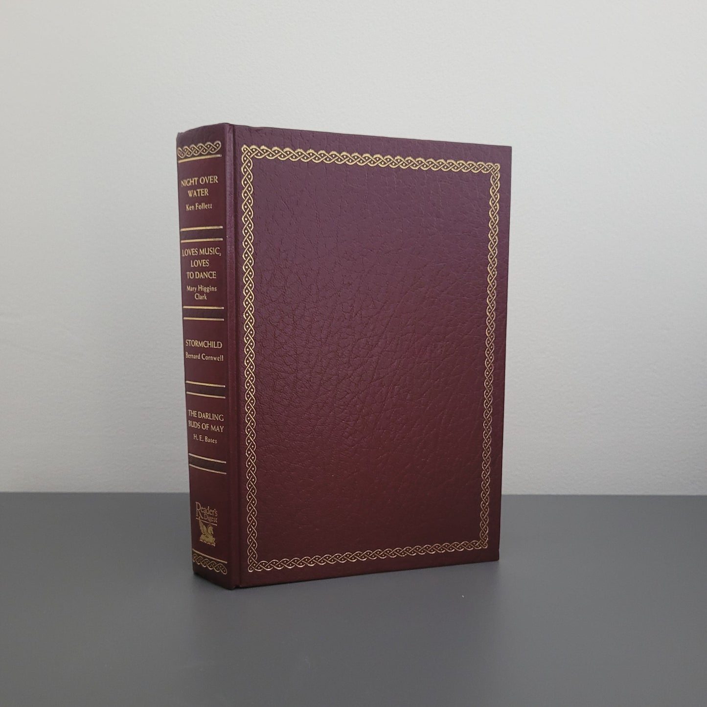 A picture of the front of the book fold - a dark red book, with a golden border.