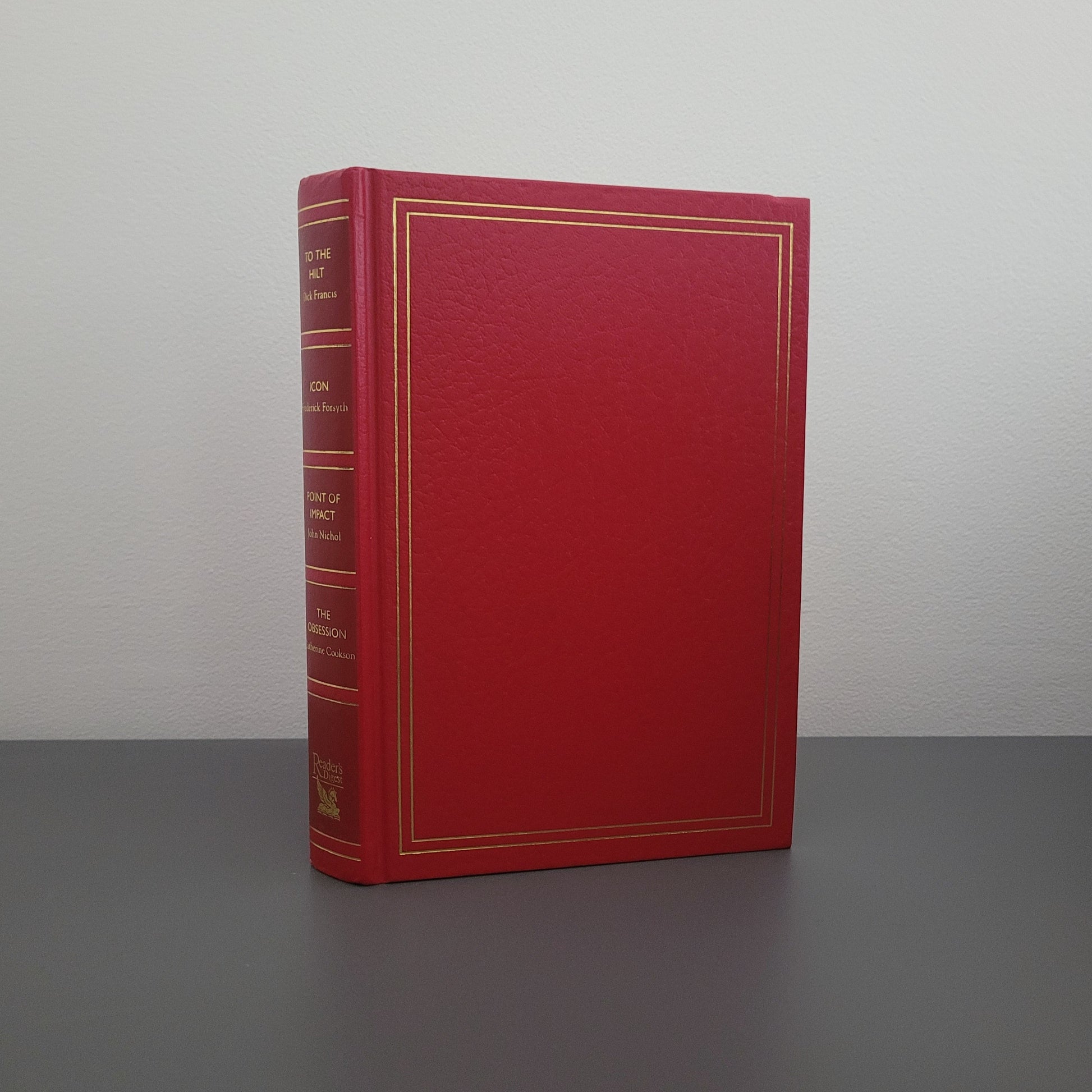 A picture of the front of the book fold - a red hardback book with a gold border