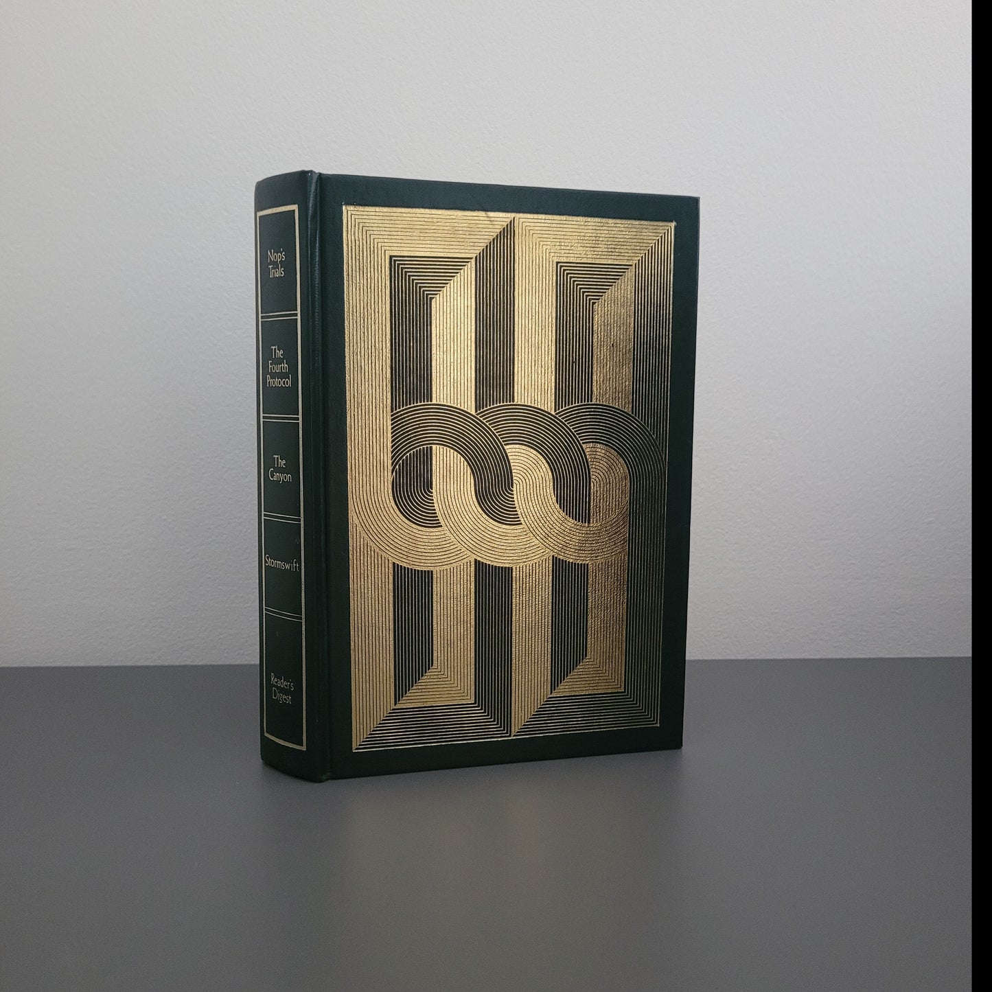 A picture of the front of the book fold - a dark green hardback with a gold pattern on.