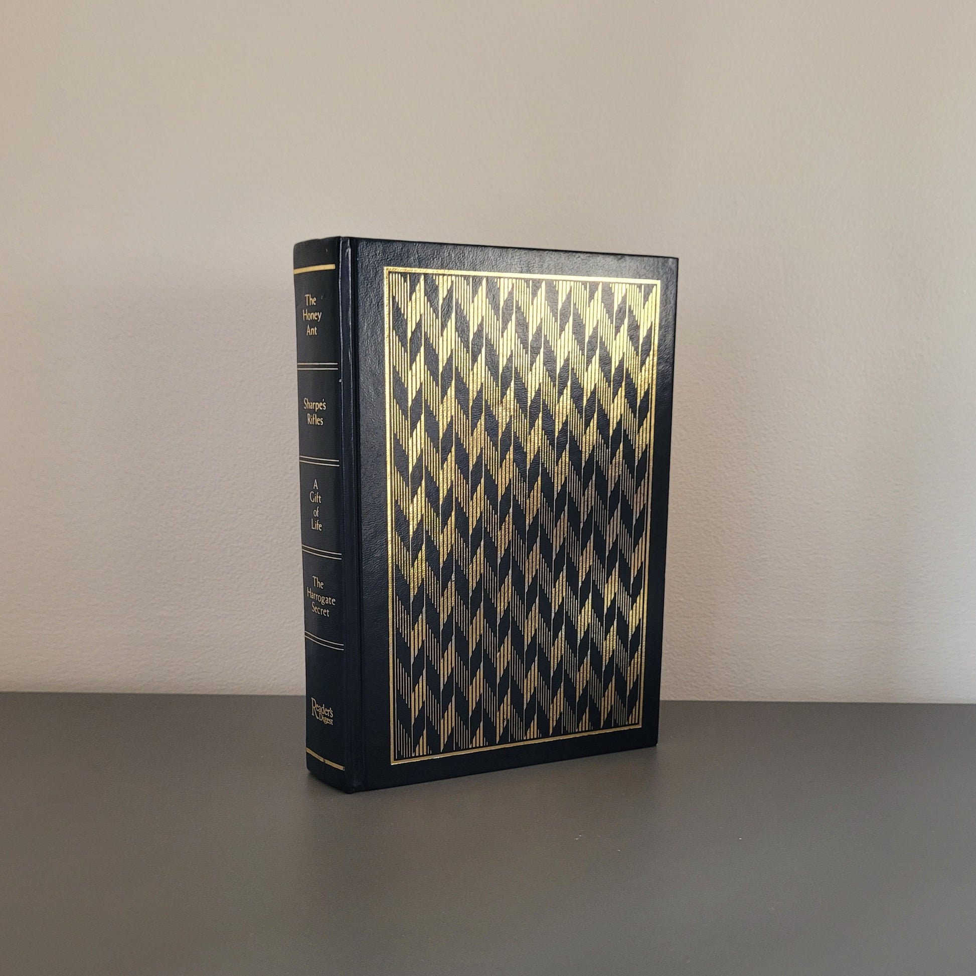 A picture of the front of the book fold - a dark blue hardback book with a shiny pattern on.
