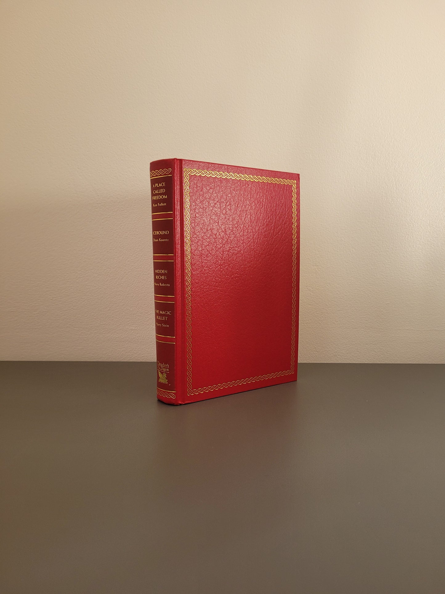 A picture of the front of the hardback - a red book with a golden border.