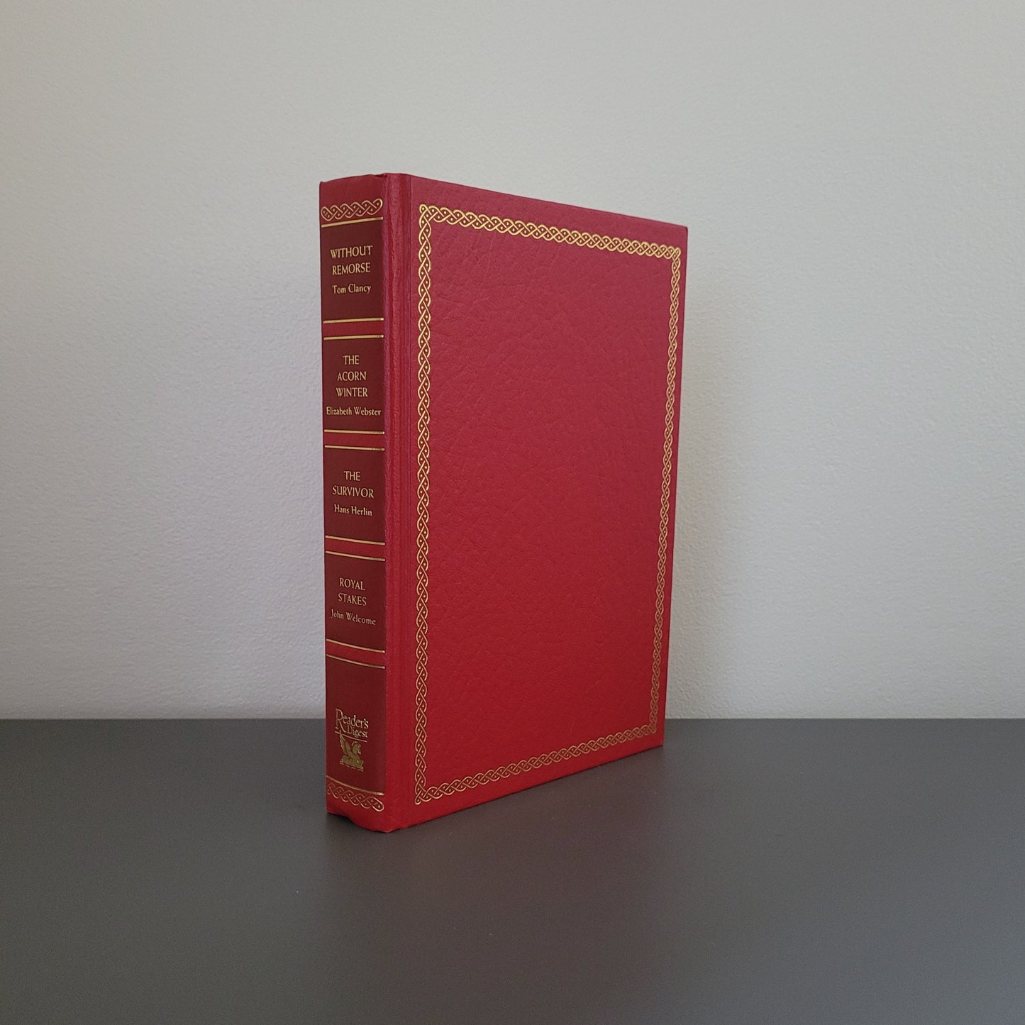 A picture of the front of the book fold - a red hardback book with a gold border.