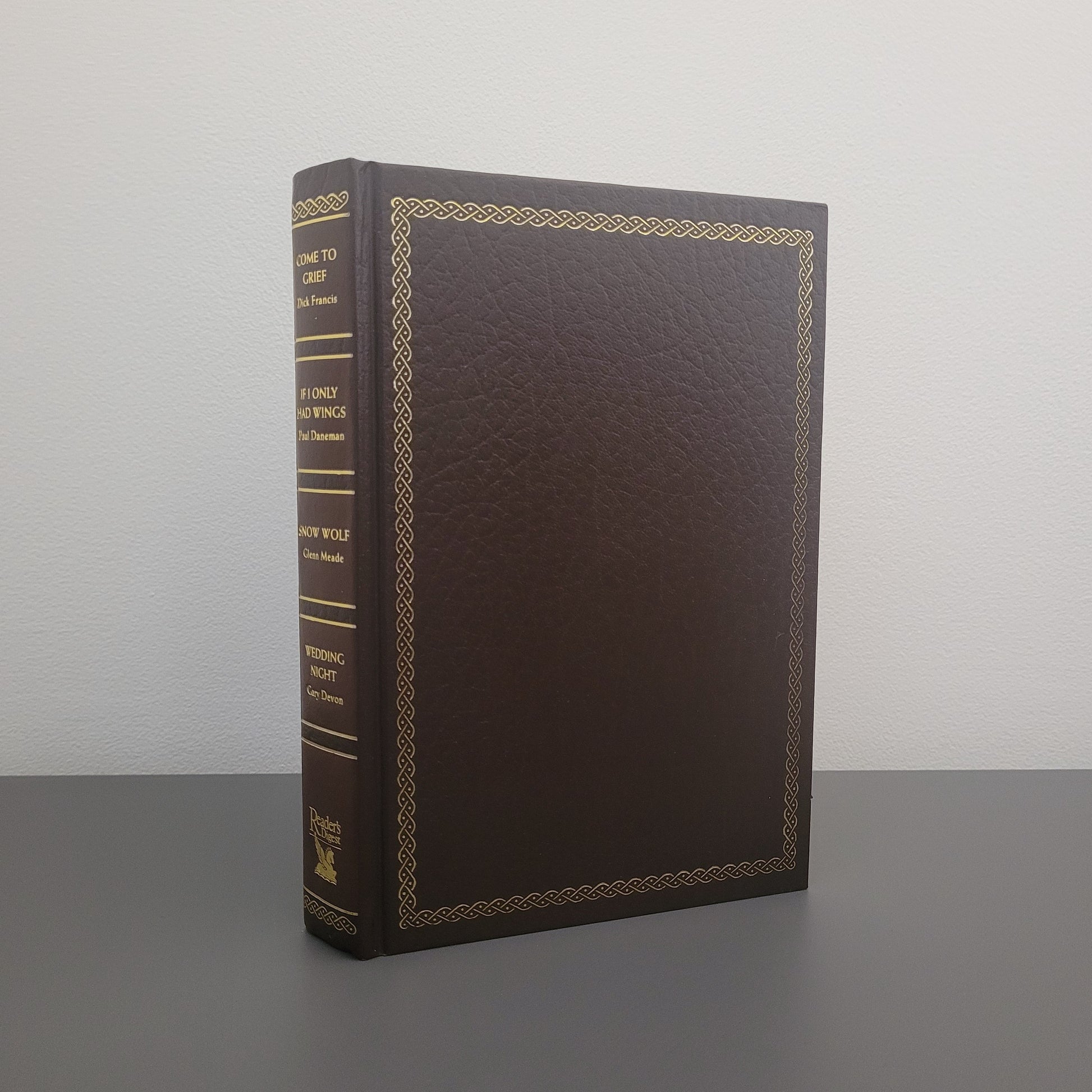 A picture of the front of the book fold - a brown hardback book with a gold border.