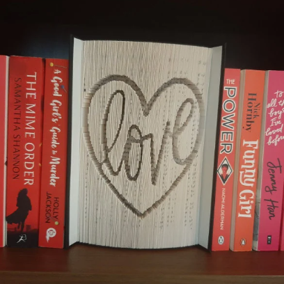 A picture of a book fold, with the word "Love" on the front, in a heart