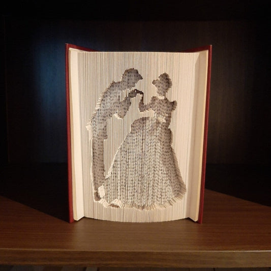 A book fold with the silhouette of Cinderella and Prince Charming on the front