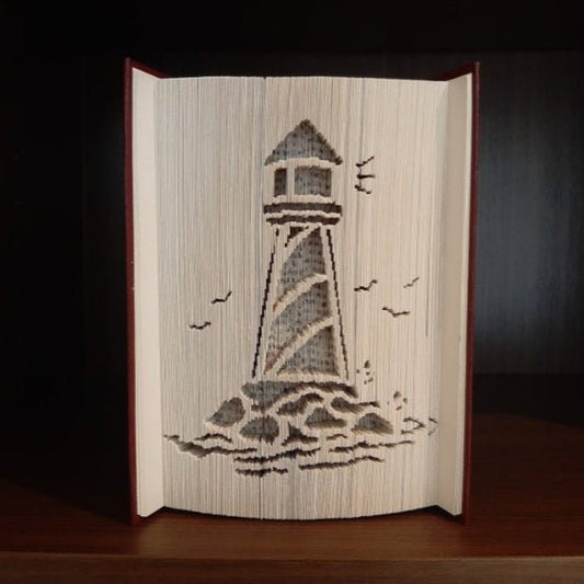 A picture of a book fold with a lighthouse on the front.